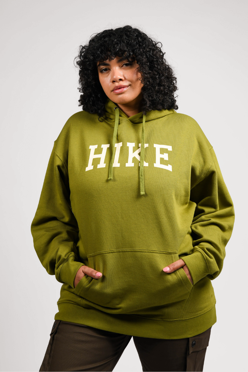 plus size woman in green pullover outdoor hoodie with pockets #color_matcha