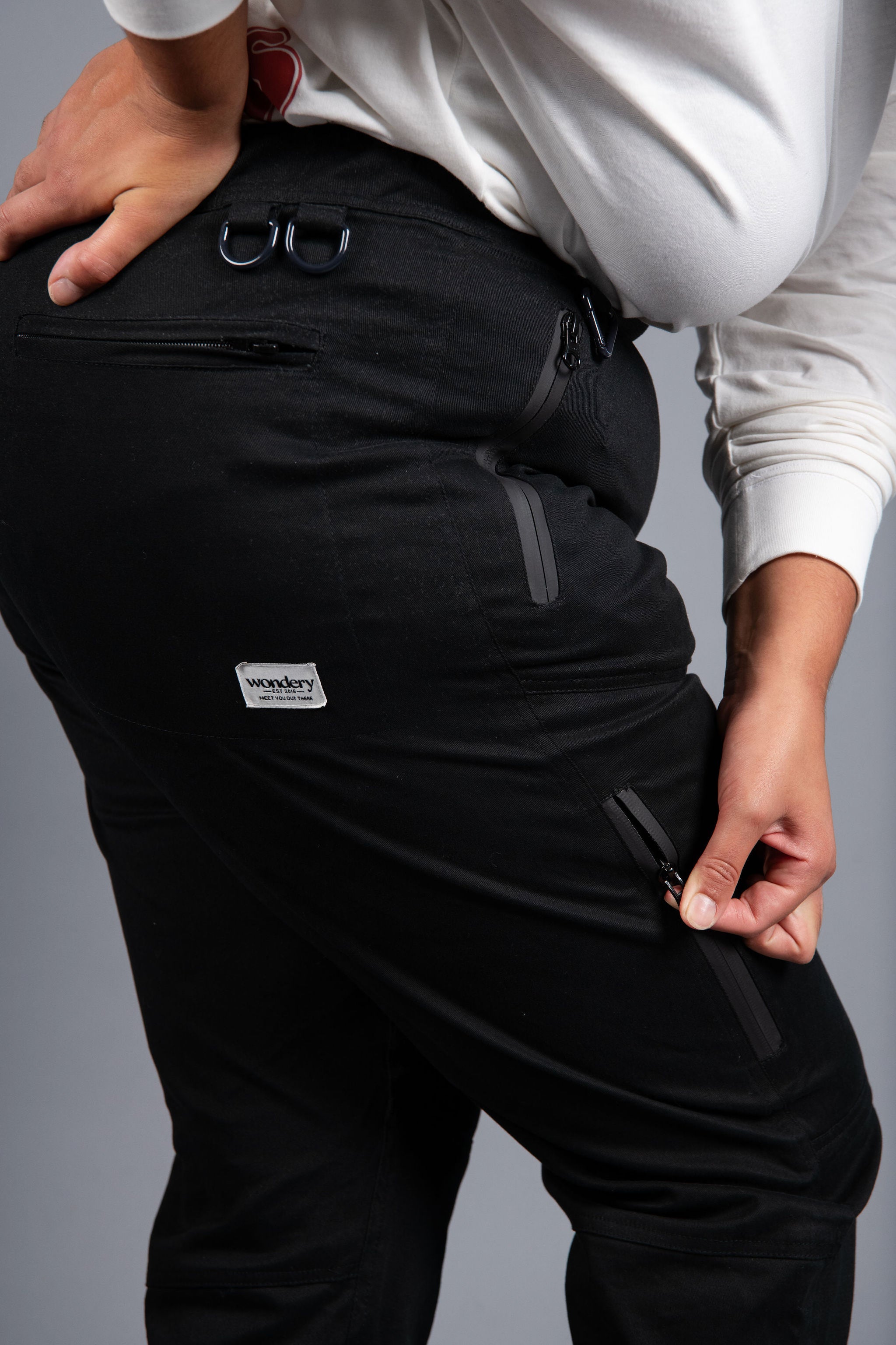 woman in adjustable black hiking pants and long sleeve top #color_black