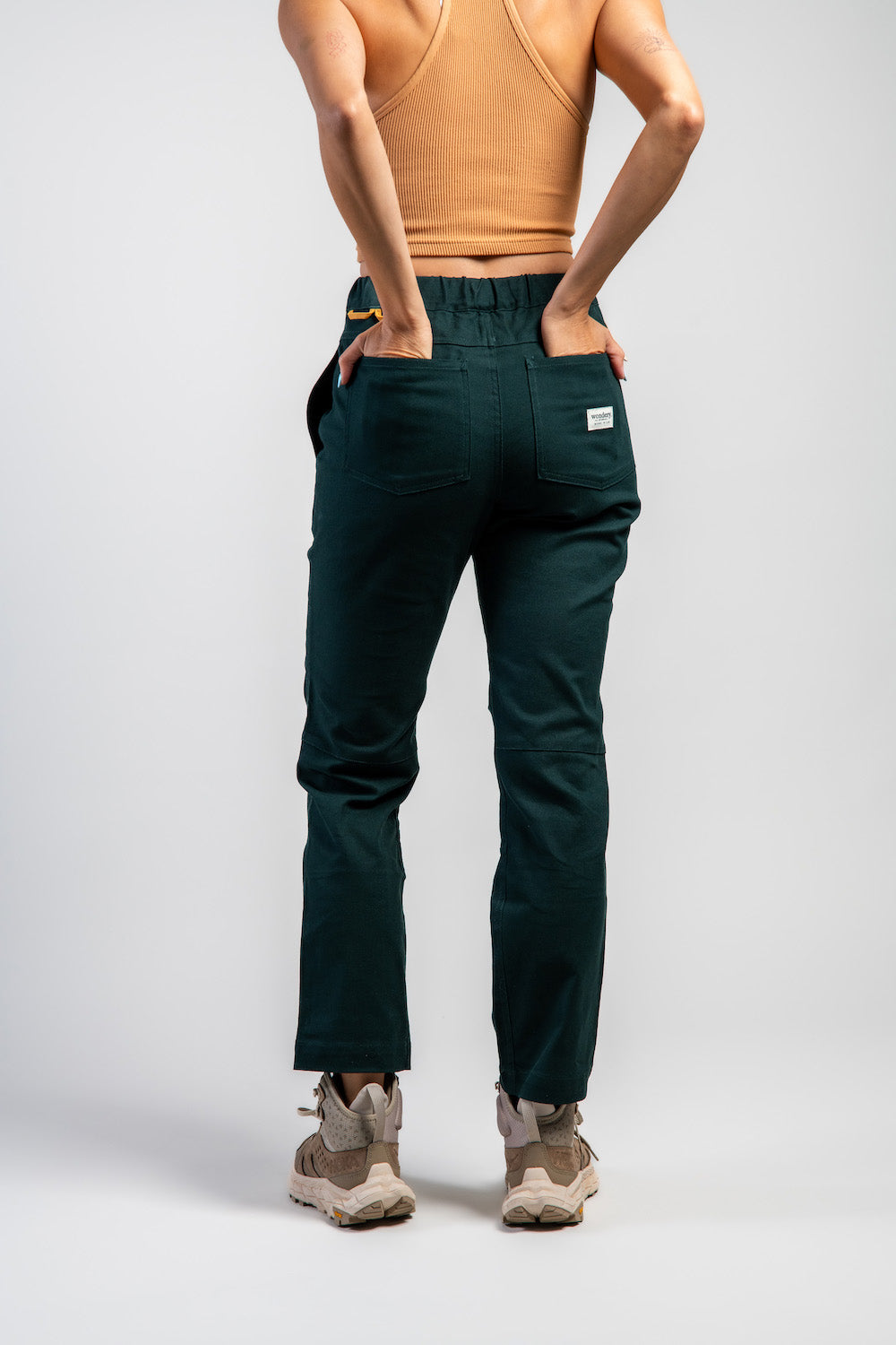 Woman in casual straight leg pants and orange tank top #color_emerald