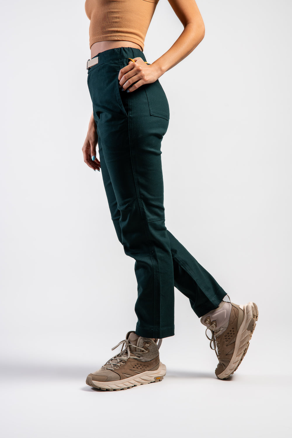 Woman in casual straight leg pants and orange tank top #color_emerald