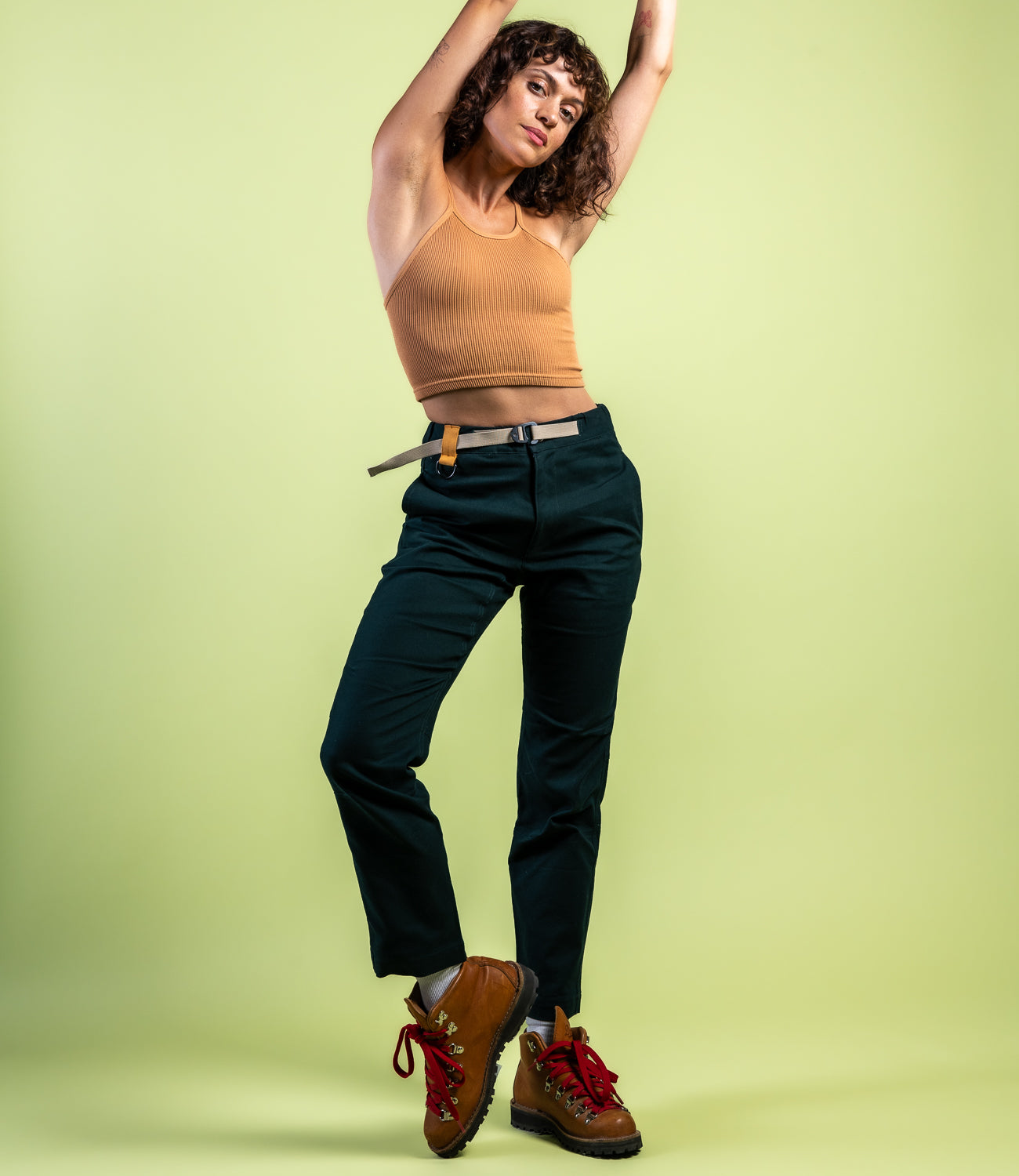 Woman in casual straight leg pants and orange tank top #color_emerald