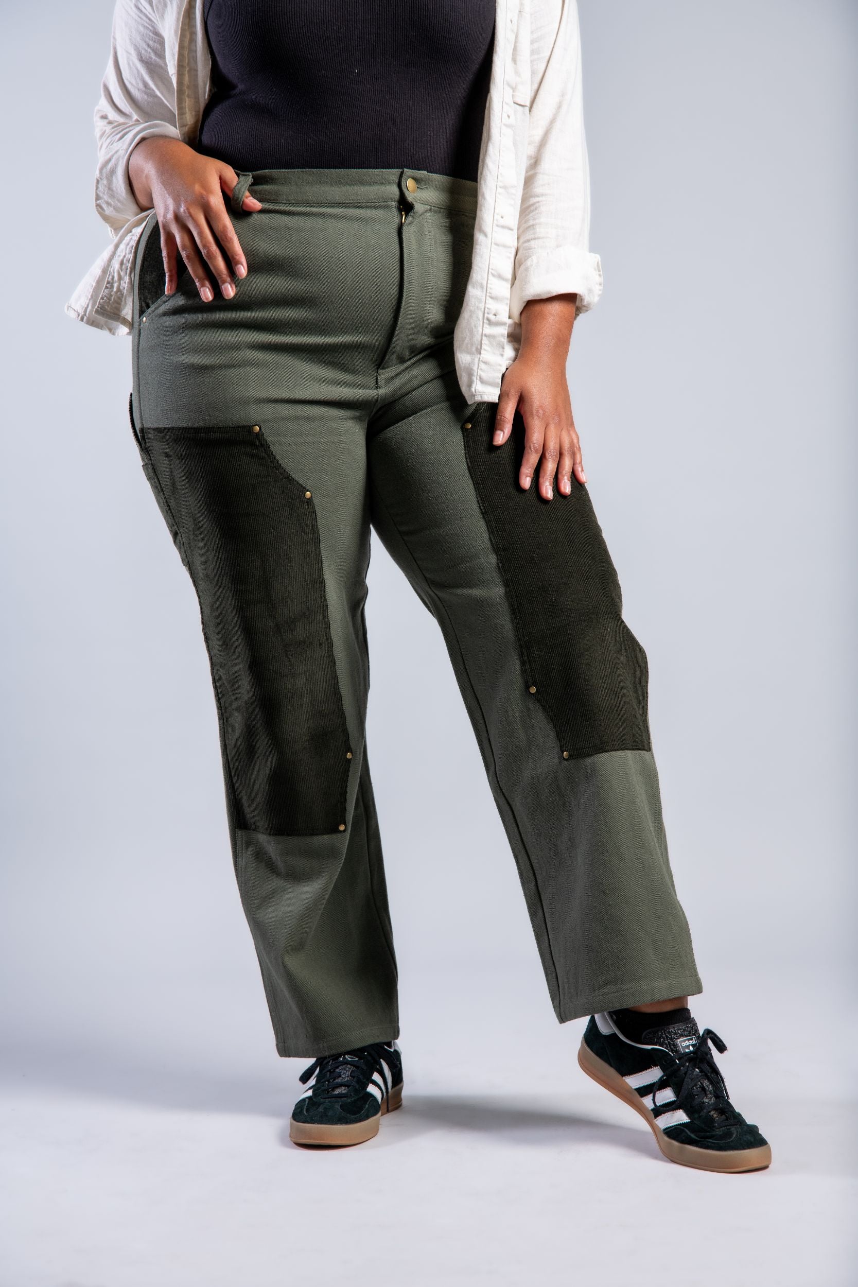 plus size woman in straight leg patchwork denim pants and adidas #color_forest