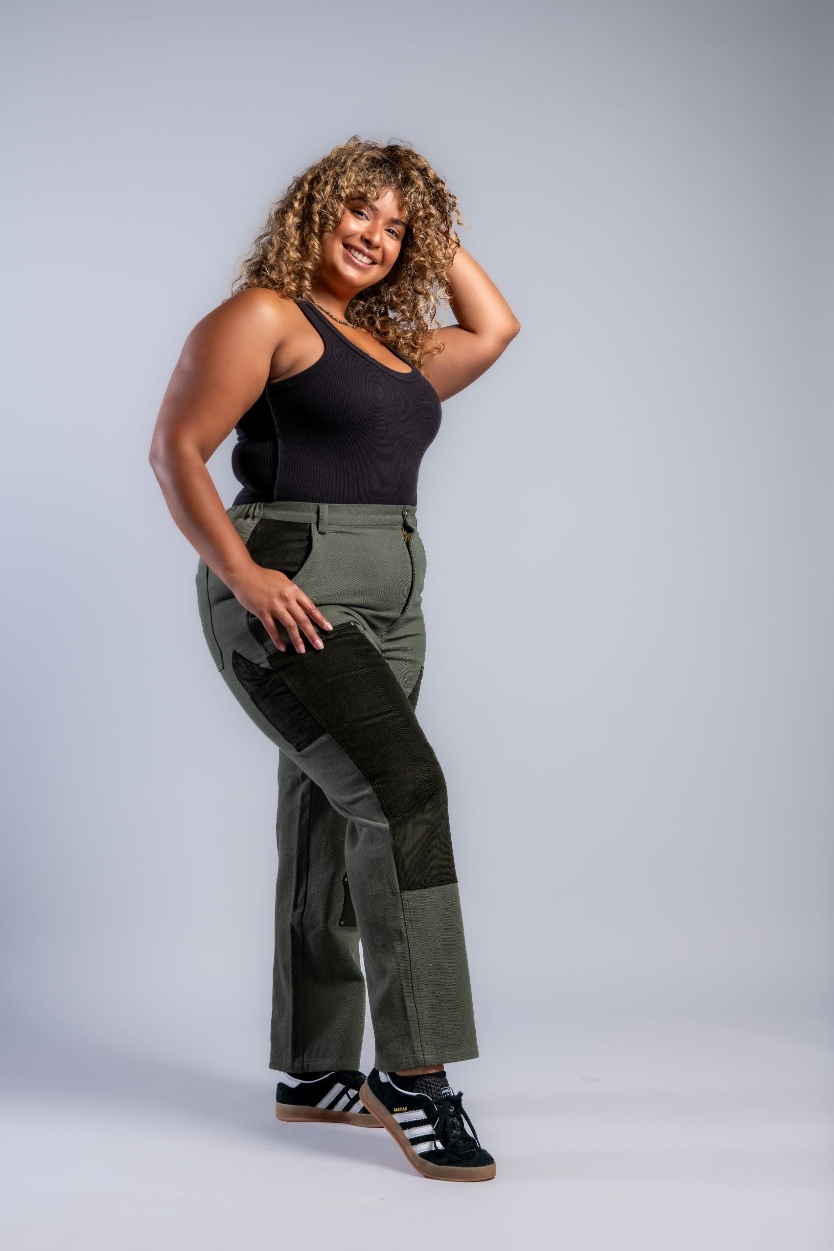 plus size woman in straight leg patchwork denim pants and adidas sneakers #color_forest