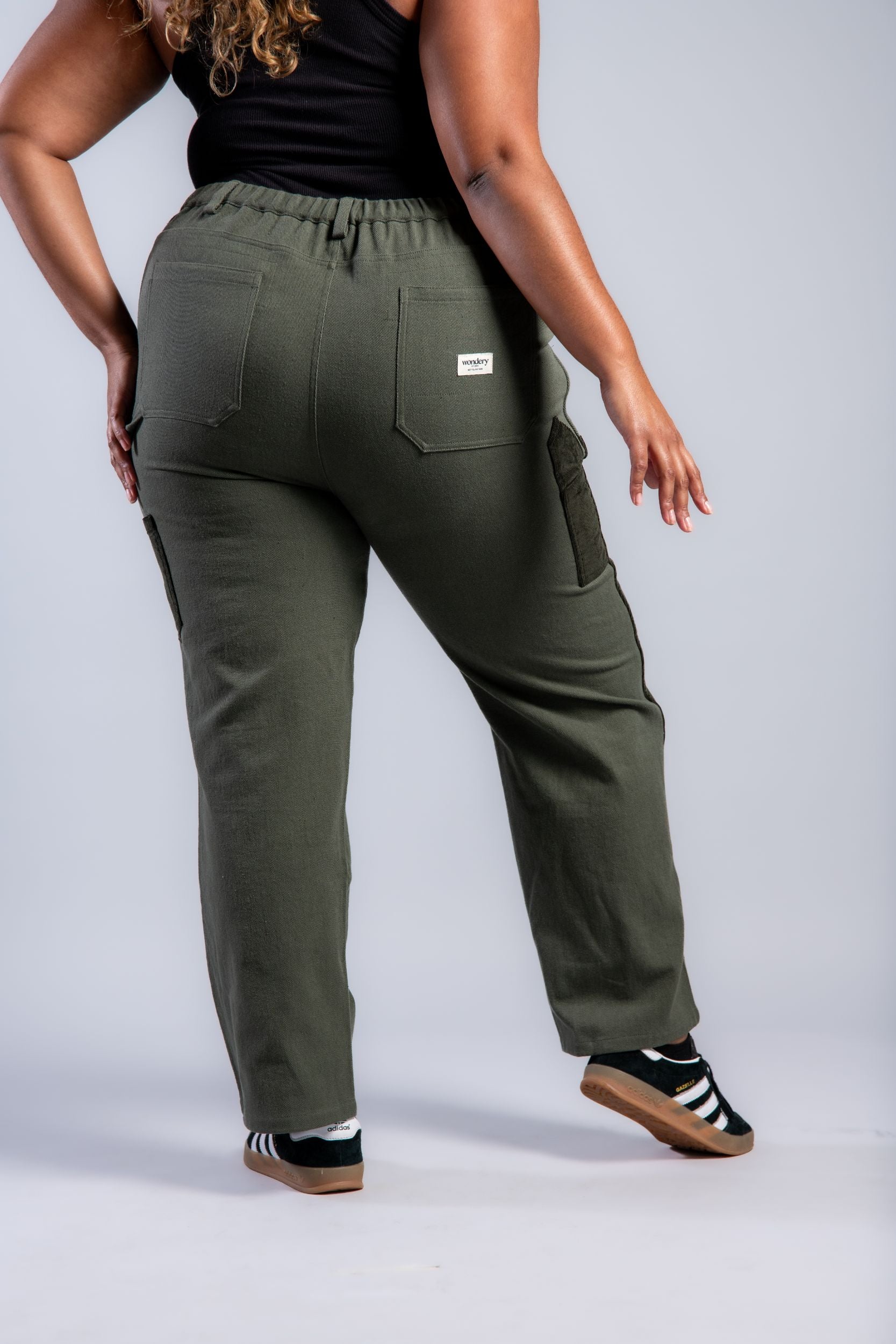 plus size woman in straight leg patchwork denim pants #color_forest