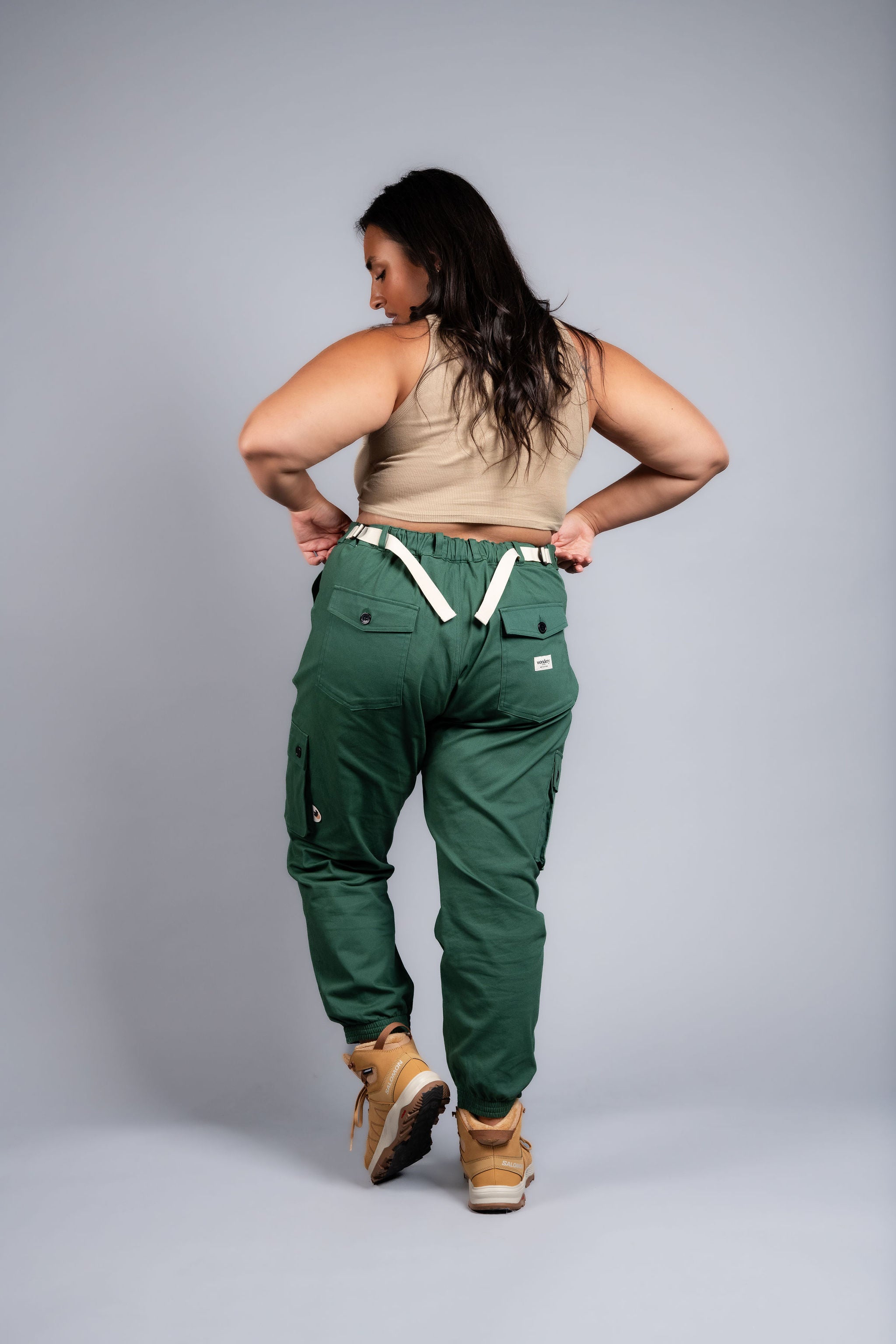 woman in adjustable green cargo hiking pants and tank top #color_sagebrush