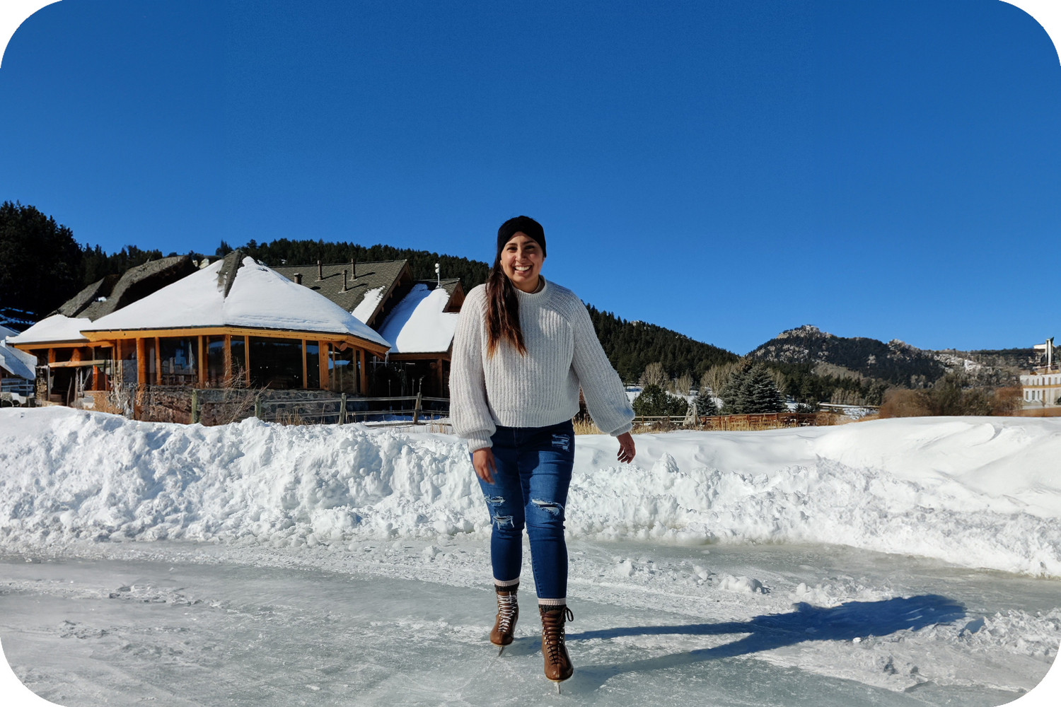 BIPOC woman ice skating on frozen lake in Colorado