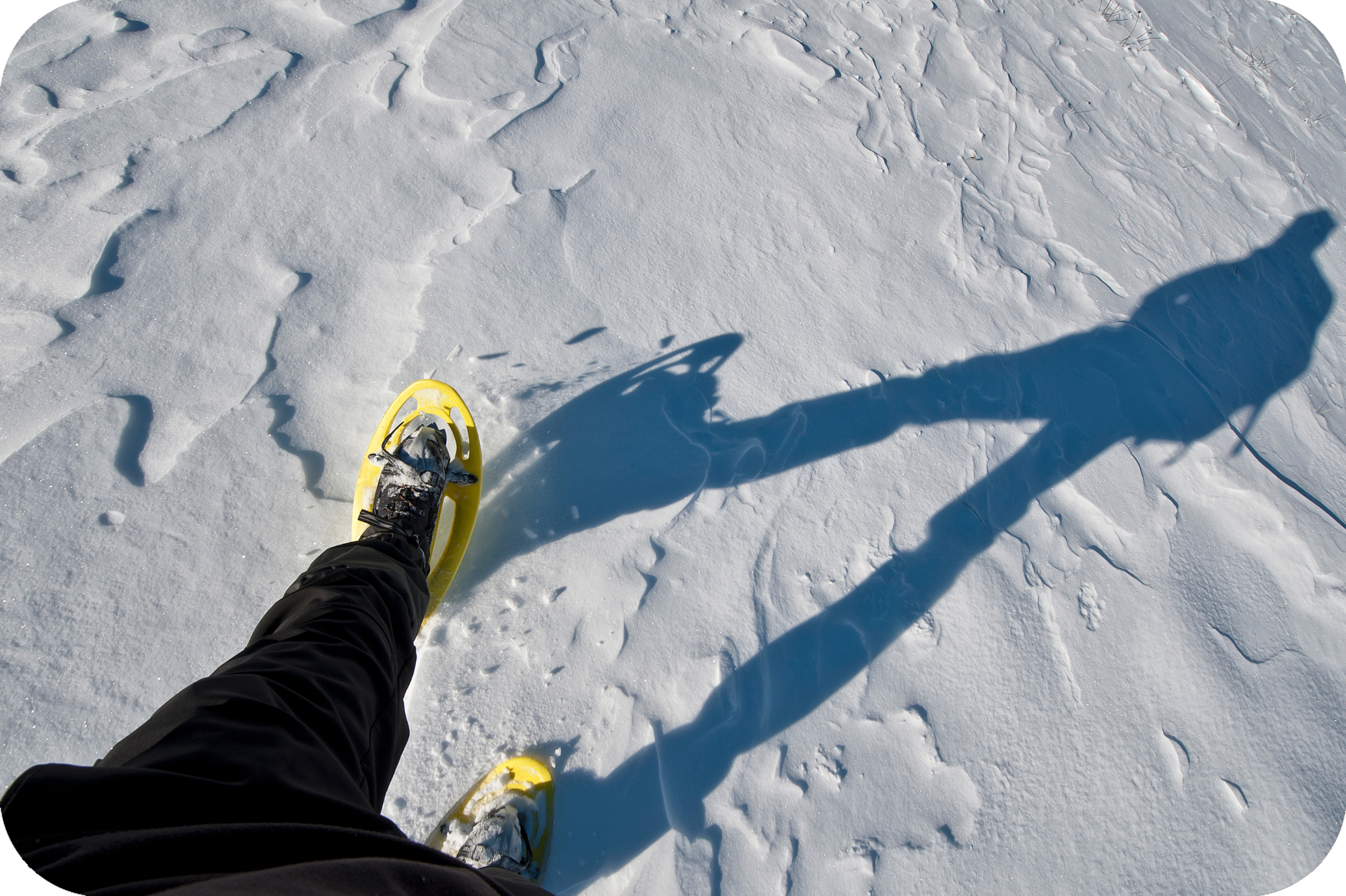 woman or man snowshoeing in the snow winter activity