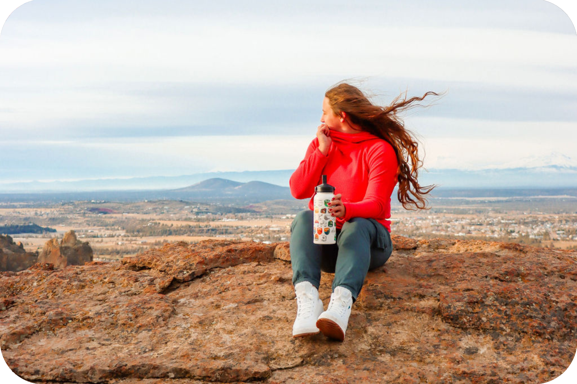Woman sitting on mountain with a view of nature