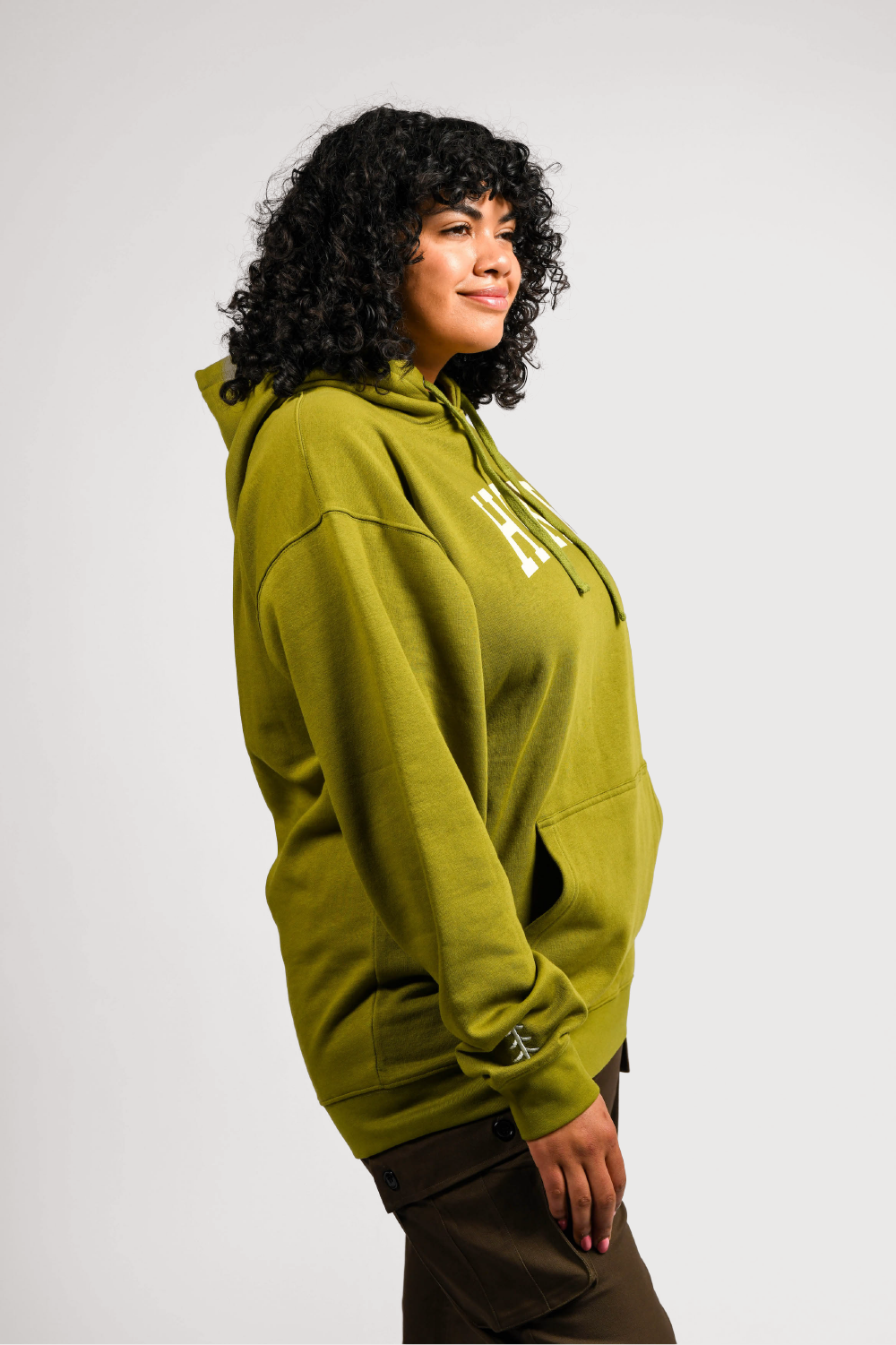 plus size woman in green pullover outdoor hoodie with pockets #color_matcha
