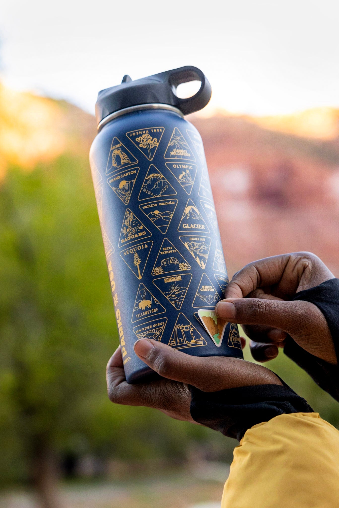 Women in outdoor camping gear with blue travel bottle