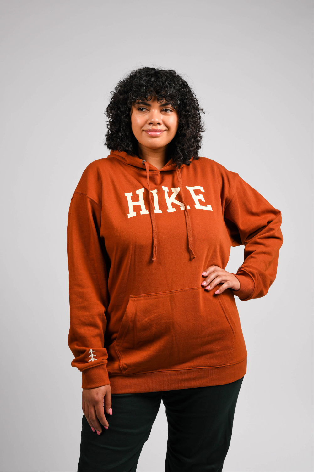 plus size woman in orange pullover outdoor hoodie with pockets #color_rust brown