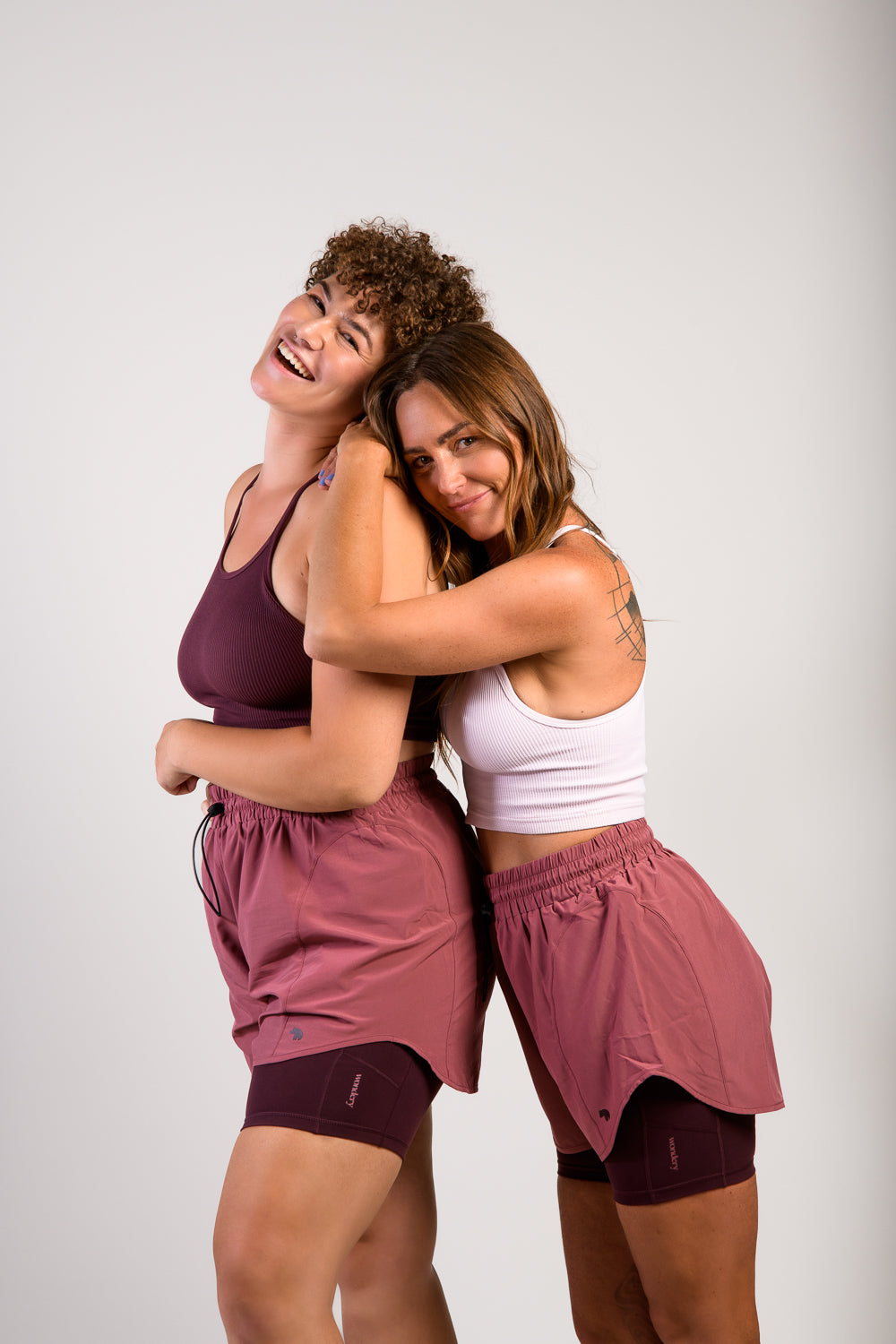 petite and tall size women in burgundy pink lightweight running shorts and biker shorts with side pocket and tank top #color_dusty rose/mauve