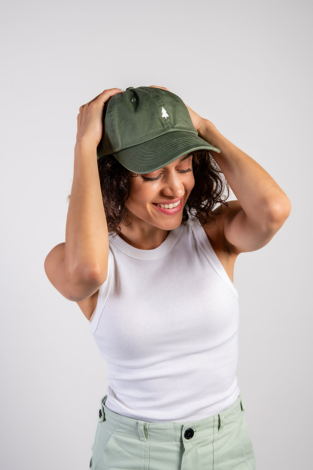 woman in green travel hiking camping outdoor hat and white tank top #color_vintage green
