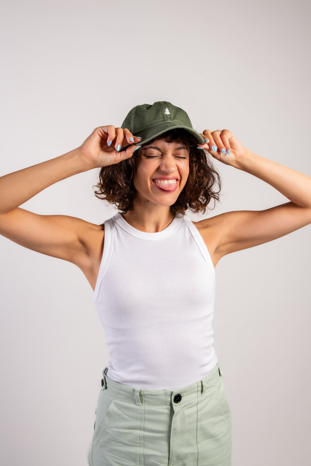 woman in green travel hiking camping outdoor hat and white tank top #color_vintage green