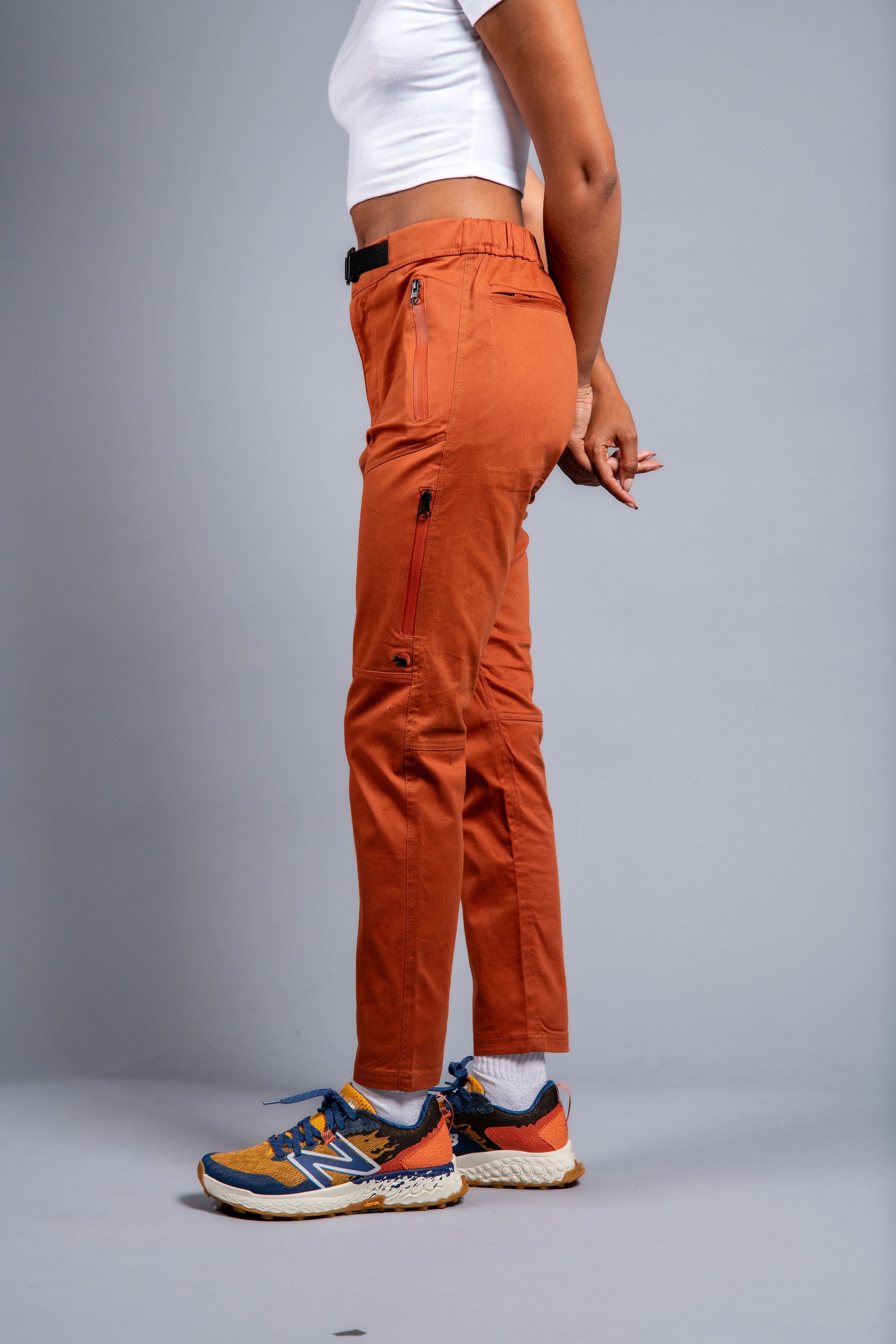 woman in adjustable orange hiking pants and tee shirt #color_red rocks