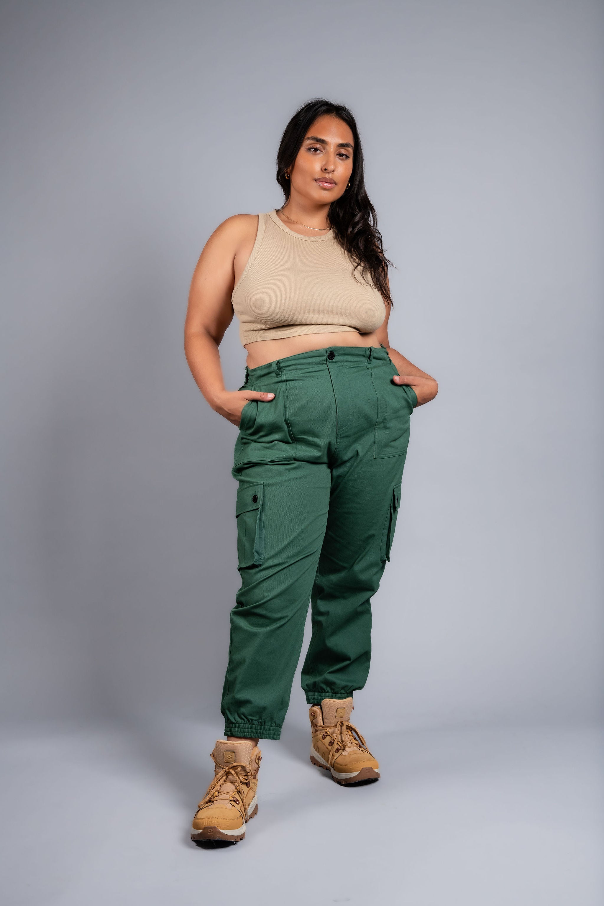 woman in adjustable green cargo hiking pants and tank top #color_sagebrush