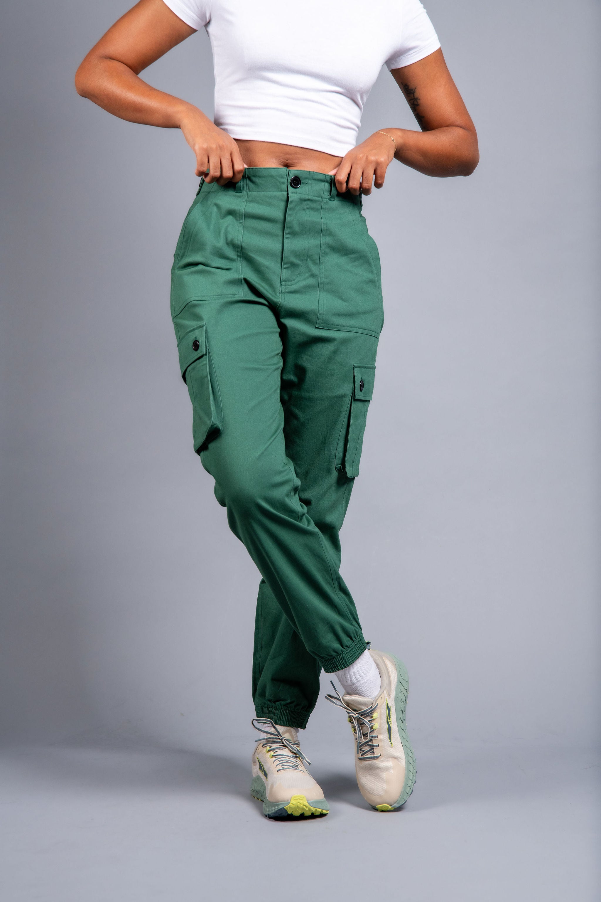 woman in adjustable green cargo hiking pants and tee shirt #color_sagebrush