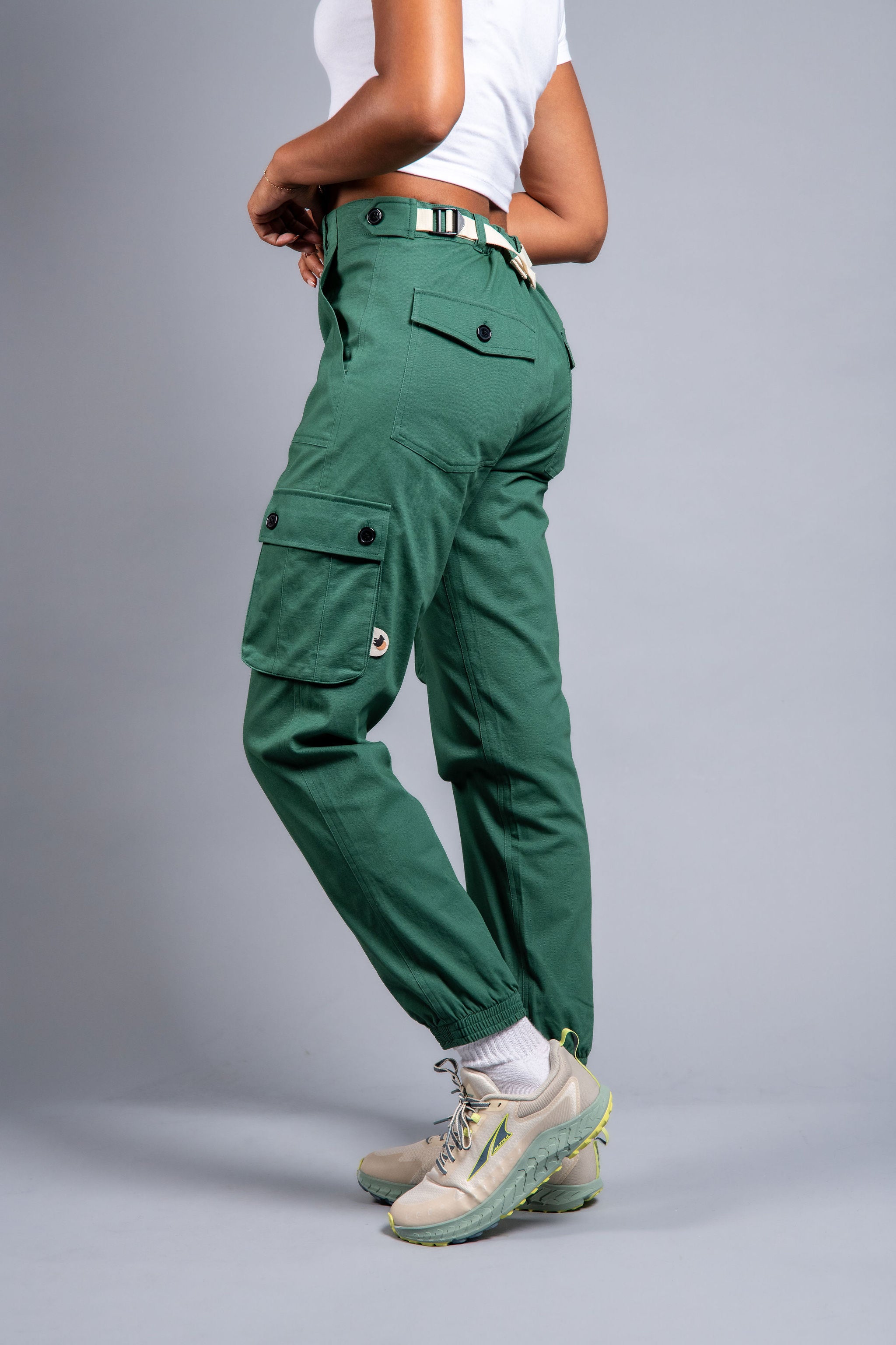 woman in adjustable green cargo hiking pants and tee shirt #color_sagebrush